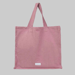 Pink tote bag with a stitched logo that reads 'Les Pensionnaires'