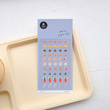 Sheet of colorful stickers on a white tray with a light gray background